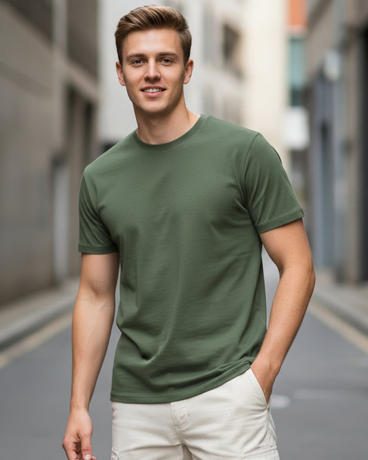 Young male model in a streetwear outfit wearing an olive green regular fit t-shirt paired with off-white cargo pants.