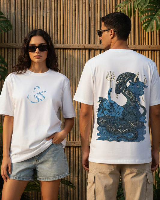 The "Shiva Samudra: The Divine Serpent Oversized Tee" in white, showcasing a detailed back-print of Lord Shiva resting on the snake Vasuki with Nandi and a trishul, and a minimalist blue Om symbol on the front chest.