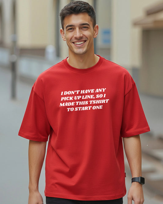 Front view of a smiling man wearing an oversized red t-shirt with the white text "I DON'T HAVE ANY PICK UP LINE, SO I MADE THIS TSHIRT TO START ONE" printed on the chest.